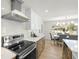 Modern kitchen featuring stainless steel appliances, bright white cabinetry, and an adjacent dining area at 3801 Dr Martin Luther King Jr N St, St Petersburg, FL 33703