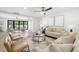 Bright living room with neutral furniture, modern decor, and a view to a peaceful outdoor space at 3801 Dr Martin Luther King Jr N St, St Petersburg, FL 33703