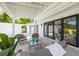 Covered outdoor patio features lounge chairs, glass table, and sliding glass doors at 3801 Dr Martin Luther King Jr N St, St Petersburg, FL 33703