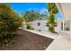 Well-maintained side yard with manicured garden beds and lush landscaping at 3801 Dr Martin Luther King Jr N St, St Petersburg, FL 33703