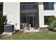Backyard with a screened patio and an air conditioning unit at 420 Moorings Cove Dr # 420, Tarpon Springs, FL 34689