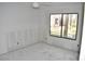 Unfinished bedroom featuring a large window with outside views, perfect for creating a cozy retreat at 420 Moorings Cove Dr # 420, Tarpon Springs, FL 34689