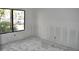 Bright bedroom with smooth concrete floors and a large window, offering modern potential at 420 Moorings Cove Dr # 420, Tarpon Springs, FL 34689