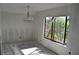 A dining room space featuring a modern chandelier and a large window with a view to the street at 420 Moorings Cove Dr # 420, Tarpon Springs, FL 34689