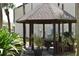 Community gazebo with picnic table and seating, surrounded by lush landscaping at 420 Moorings Cove Dr # 420, Tarpon Springs, FL 34689