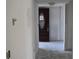 Hallway of condo undergoing renovation, featuring bare walls and view of front door at 420 Moorings Cove Dr # 420, Tarpon Springs, FL 34689