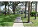 Community kayak storage area with a sidewalk and landscaped lawn at 420 Moorings Cove Dr # 420, Tarpon Springs, FL 34689