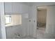 Bright kitchen with white cabinetry ready for updates and personalization with a garden view at 420 Moorings Cove Dr # 420, Tarpon Springs, FL 34689