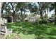 View of a spacious lawn and recreational area with benches and kayak storage at 420 Moorings Cove Dr # 420, Tarpon Springs, FL 34689