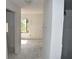 Living room of condo undergoing renovation, featuring bare walls, single window and doorway at 420 Moorings Cove Dr # 420, Tarpon Springs, FL 34689
