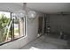 A light-filled living area enhanced by a chandelier and sliding glass doors with waterfront views at 420 Moorings Cove Dr # 420, Tarpon Springs, FL 34689