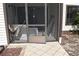 Screened in patio area with tile floor and showing construction debris at 420 Moorings Cove Dr # 420, Tarpon Springs, FL 34689