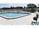 Community pool with fence and beautiful water view at 420 Moorings Cove Dr # 420, Tarpon Springs, FL 34689