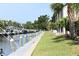 Scenic waterfront view featuring a boat dock, canal, and lush landscaping at 420 Moorings Cove Dr # 420, Tarpon Springs, FL 34689