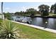A scenic view of a canal with a boat at the dock at 420 Moorings Cove Dr # 420, Tarpon Springs, FL 34689