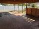 Covered back patio perfect for outdoor entertaining with an area for storage and a fenced in yard at 4506 Eden Rock Rd, Tampa, FL 33634