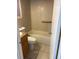 Clean bathroom featuring a tiled tub, a modern toilet, and a vanity with neutral countertops at 4506 Eden Rock Rd, Tampa, FL 33634