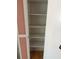 A spacious, empty closet with multiple shelves and a light wooden floor at 4506 Eden Rock Rd, Tampa, FL 33634