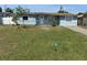 Charming single-story home with light blue exterior and a spacious front yard at 4506 Eden Rock Rd, Tampa, FL 33634