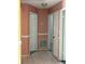 Hallway with tile floors, neutral-toned walls, and multiple doorways leading to different rooms at 4506 Eden Rock Rd, Tampa, FL 33634