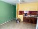Modest kitchen featuring a stainless steel sink, dark cabinets, and vibrant colored walls at 4506 Eden Rock Rd, Tampa, FL 33634