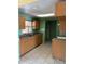 Traditional kitchen featuring light-colored cabinets, tile floors, and a double sink beneath a window at 4506 Eden Rock Rd, Tampa, FL 33634
