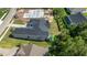 Aerial view of a home with extensive landscaping, a patio, and a view of surrounding greenery at 4522 Majestic Hills Loop, Brooksville, FL 34601
