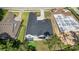 Aerial view of property showcasing the roofline, landscaping, hardscaping, outdoor living space, and neighboring construction at 4522 Majestic Hills Loop, Brooksville, FL 34601