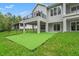 Spacious backyard with putting green, balcony, and covered patio is great for outdoor entertainment at 4522 Majestic Hills Loop, Brooksville, FL 34601