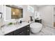 A luxurious bathroom featuring dual vanities, a freestanding tub, marble floors, and modern lighting at 4522 Majestic Hills Loop, Brooksville, FL 34601