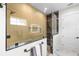 Bathroom with modern design, featuring a glass-enclosed shower with gold hardware and marble counters at 4522 Majestic Hills Loop, Brooksville, FL 34601