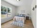 Sunlit bedroom featuring a queen-sized bed, hardwood floors, and neutral decor at 4522 Majestic Hills Loop, Brooksville, FL 34601
