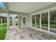 Serene outdoor space with stone pavers and sliding glass doors provides an inviting atmosphere at 4522 Majestic Hills Loop, Brooksville, FL 34601