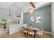 Dining room with a modern chandelier, high ceilings, and an open view to the living area at 4522 Majestic Hills Loop, Brooksville, FL 34601