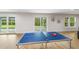 Game room with ping pong table, sliding glass doors to the outdoor area, and lots of natural light at 4522 Majestic Hills Loop, Brooksville, FL 34601