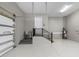 Spacious garage featuring epoxy flooring, wash sink, stairs to interior door, and a modern water heater at 4522 Majestic Hills Loop, Brooksville, FL 34601