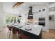 Bright kitchen boasts a large island with countertop dining, stainless steel appliances, and designer pendant lights at 4522 Majestic Hills Loop, Brooksville, FL 34601