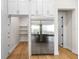 Modern kitchen with white cabinets, stainless steel appliances, and a large pantry at 4522 Majestic Hills Loop, Brooksville, FL 34601