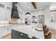 Bright kitchen boasts a large center island with quartz countertops, stainless appliances, and sleek white cabinetry at 4522 Majestic Hills Loop, Brooksville, FL 34601