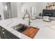 A kitchen island featuring a stainless steel sink and a wooden cutting board at 4522 Majestic Hills Loop, Brooksville, FL 34601