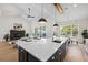 Open-concept kitchen with a large center island, breakfast bar, and living room with fireplace at 4522 Majestic Hills Loop, Brooksville, FL 34601
