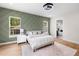 Bright main bedroom with paneled accent wall, natural light, and ensuite bathroom at 4522 Majestic Hills Loop, Brooksville, FL 34601