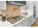 Modern kitchen with stainless steel range, marble countertops, and white custom cabinetry at 4522 Majestic Hills Loop, Brooksville, FL 34601
