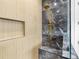 This bathroom features a shower with wood paneled walls, a marble wall, and a golden shower head at 4522 Majestic Hills Loop, Brooksville, FL 34601