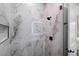 Stylish shower area features marble-look tiles, sleek, modern fixtures, and a built-in niche at 4522 Majestic Hills Loop, Brooksville, FL 34601