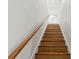 Elegant wooden staircase leading to a brightly lit upper floor, showcasing clean lines and design at 4522 Majestic Hills Loop, Brooksville, FL 34601