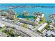 Stunning aerial view of waterfront condos offering gorgeous city and ocean views with community pool and tennis courts at 4700 Cove Cir # 301, St Petersburg, FL 33708