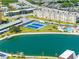 Scenic view of the property featuring a community pool, tennis courts, pond, and condo buildings at 4700 Cove Cir # 301, St Petersburg, FL 33708