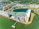 An aerial view of a waterfront condo community, showcasing the pool, condos and the surrounding landscape at 4700 Cove Cir # 301, St Petersburg, FL 33708