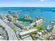 Aerial view showcasing the community, lake, tennis courts, and ocean at 4700 Cove Cir # 301, St Petersburg, FL 33708